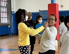 Couple in dance frame in their school gym (PS 1M) during their fall residency.