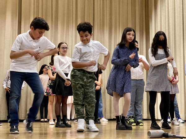 Students at their Culminating Event (PS 175Q) dancing the merengue (March 2022).