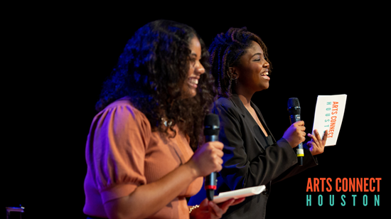 A dark background with two Black female high school students on stage holding microphones and smiling during the State of the Arts in Education Symposium, with the words Arts Connect Houston in the bottom right corner.